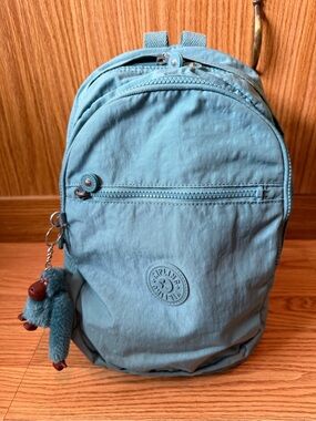 Kipling Challenger Medium Backpack in a teal color with a matching monkey charm.